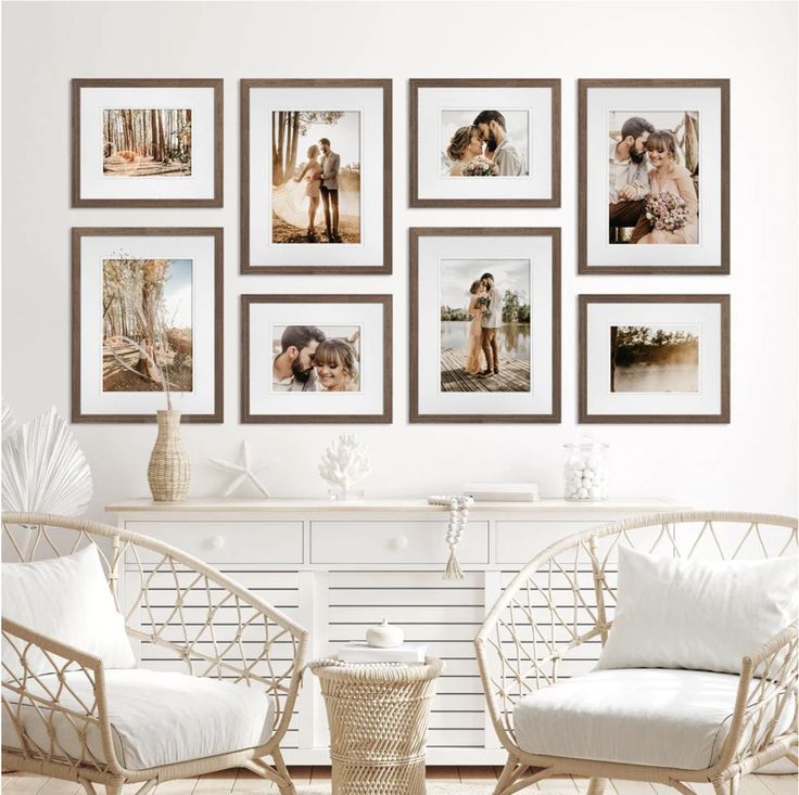 a living room with pictures hanging on the wall and two chairs in front of them