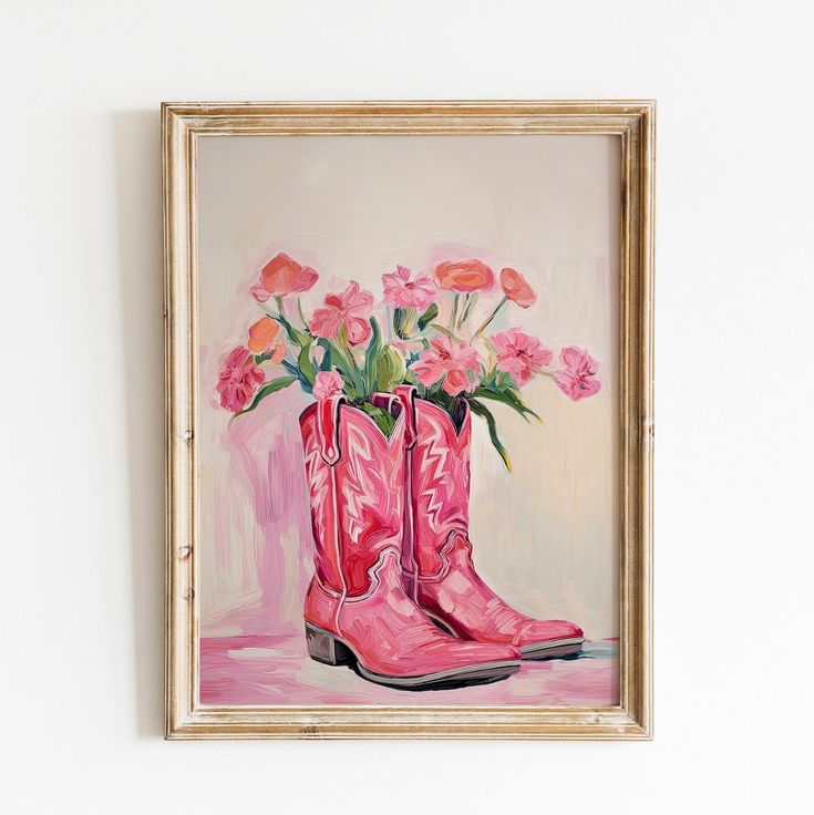 a painting of pink boots with flowers in them on a white wall above a wooden frame