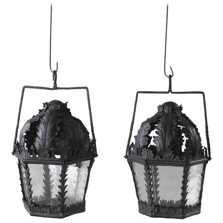 two black and white lanterns hanging from hooks