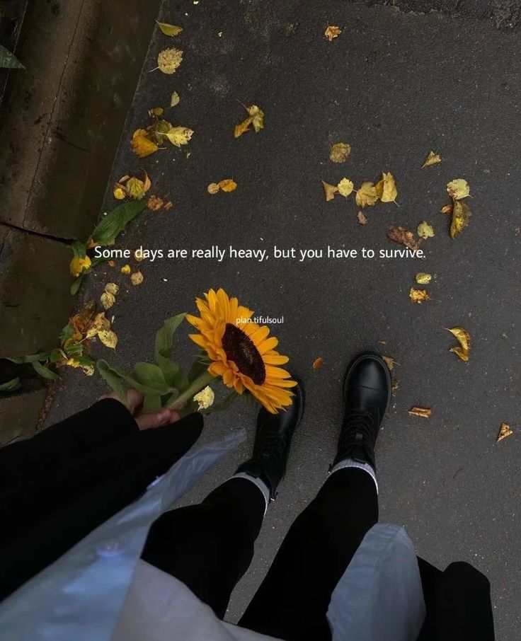 two people standing next to each other with flowers in front of them and the words some days are really heavy, but you have to survive