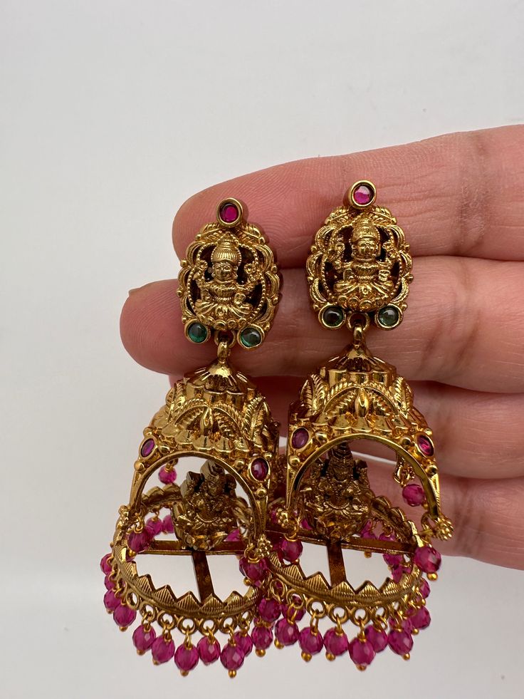 Matte Goddess Lakshmi Jhumka Earrings pushback earringsColor : Matte GoldenSize : Length : 2.5 Inches; Weight : 15 grams eachStones : AD Stones Pearls Beads Festive Temple Jewelry Earrings For Puja, Temple Jewelry Earrings With Pallu For Celebration, Bollywood Style Earrings With Intricate Design For Puja, Festive Latkan Earrings For Puja, Tilla Earrings For Puja And Diwali, Round Earrings For Puja And Festivals, Round Tilla Earrings For Puja, Kundan Earrings With Intricate Design For Puja, Temple Jewelry Jhumkas For Navratri