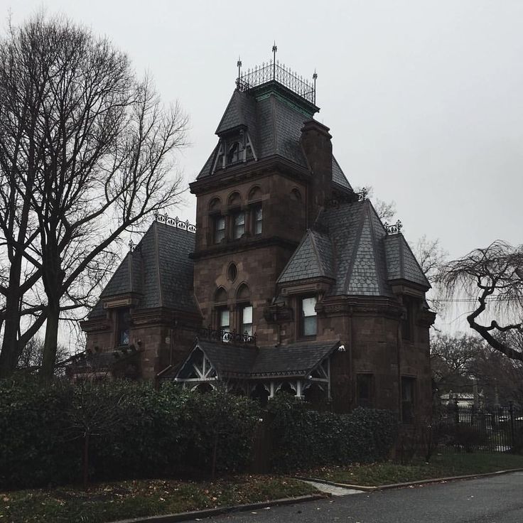 an old victorian style house in the middle of winter