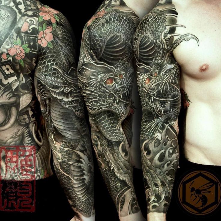 two men with tattoos on their arms and legs