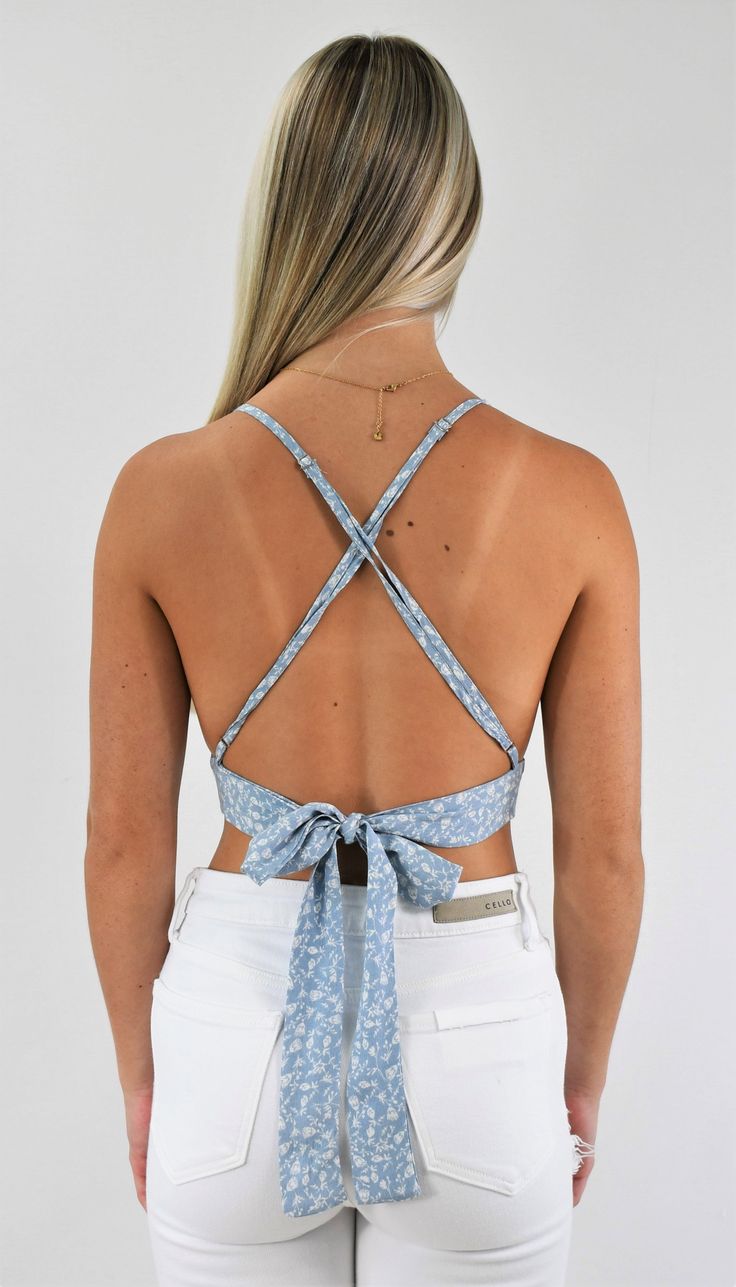 Great trendy little top. This tiny triangle crop top has adjustable straps that cross in the back for support and a back tie that customizes the fit. Wear it with a skirt for a delicate look, or pair it with your favorite jeans to add some edge. Color-Light Blue Floral (Also available in Gold Floral) 100% Rayon Chic Crop Top With Built-in Bra And Strappy Back, Chic Cross Back Tie Back Top, Vacation Tops With Tie Back And Backless Shape, Vacation Tops With Tie Back And Backless Design, Chic Cross Back Top With Tie Detail, Casual Crop Top With Built-in Bra And Strappy Back, Vacation Backless Top With Tie Back, Vacation Tie Back Backless Tops, Spring Backless Halter Top With Built-in Bra