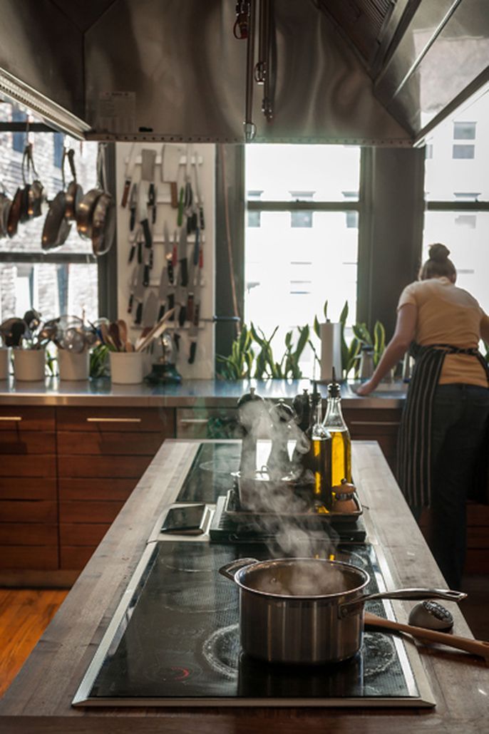 a kitchen filled with lots of counter top space and cooking utensils on the stove