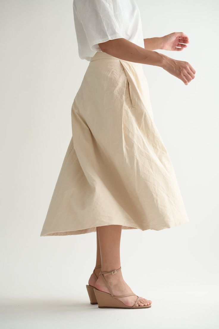 Casey Casey Moon Skirt in Ecru. Pleated skirt in washed cotton with a tailored waist and back button and zip closure. Front pleats hide pockets, while the back pleat creates volume. Lined in cotton. 99% cotton, 1% polyester, 100% cotton lining. Made in France. XS - 27" waist, 33" lengthS - 28" waist, 34" length Chic Cotton Gathered Skirt Bottoms, Cotton Pleated Skirt With Relaxed Fit, Beige Flared Skirt For Daywear, Cotton Pleated Skirt With Relaxed Fit For Daywear, Chic Linen Full Skirt Bottoms, Chic Cotton Pleated Summer Skirt, Chic Cotton Flowy Skirt, Chic Full Skirt Bottoms In Linen, Chic Pleated Cotton Skirt For Summer