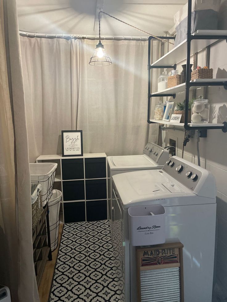 a washer and dryer sitting in a room next to a shelf filled with items