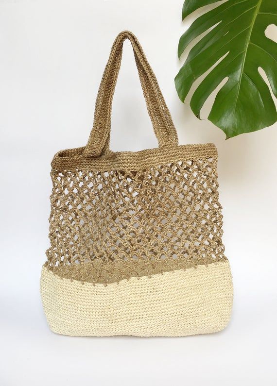 Stylish and on trend, this beautiful tote is handmade by artisans from Santander, Colombia. 100% made of Fique natural fiber, a plant similar to Agave, it is the perfect summer accessory to be used out in the city or to spend a day at the beach. With two easy to carry handles, you will want to carry it around everywhere you go!Approximate Dimensions:Height: 17" / 43 cmWidth: 16.1” / 41 cmStrap drop: 9"/ 23 cmAll of our bags are 100% handmade from natural fibers. Please allow for any color and si Neutral Rectangular Shoulder Bag For Beach, Rectangular Neutral Shoulder Bag For Beach, White Natural Fiber Travel Bag, Natural Palm Leaf Crochet Bag For Vacation, Natural Open Weave Shoulder Bag For Beach, Eco-friendly Open Weave Shoulder Bag For Beach, Beach Shoulder Bag With Open Weave In Natural Color, Handwoven Rectangular Straw Bag In Neutral Color, Eco-friendly Beige Shoulder Beach Bag