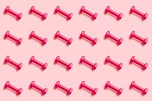 a pink background with several red plastic pegs