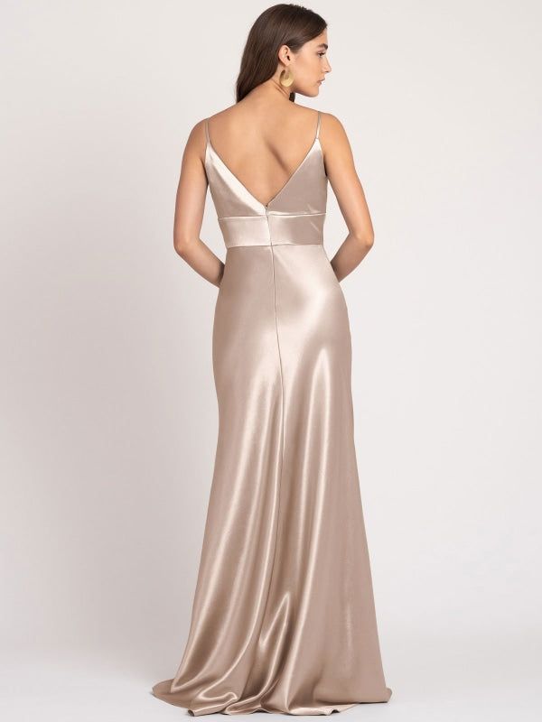 the back of a woman wearing a champagne colored gown