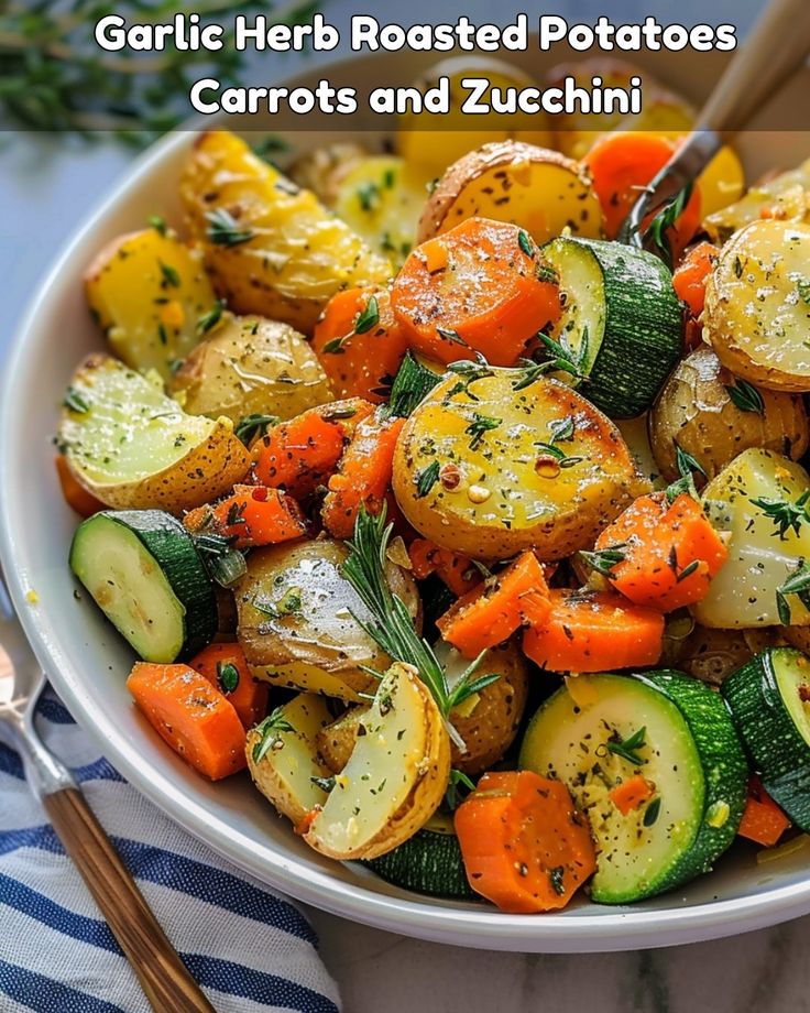 a bowl full of roasted potatoes and carrots with herbs in the top left corner