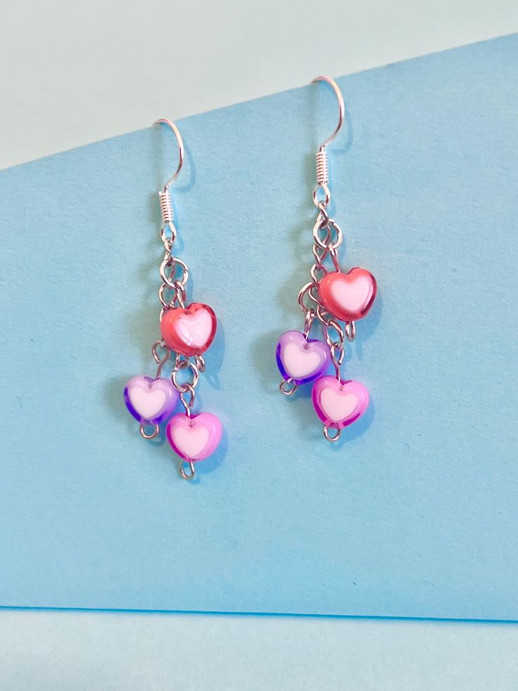 Heart cluster dangler earrings, to brighten up your day. Dainty and cute. Perfect Valentine present. The hook is plated sterling silver to protect your ears and the the love hearts are made of polymer. They come well presented and wonderful for a birthday present for a friend, family or your loved one. I offer free postage and will despatch within a day of purchase Thank you for taking the time to look at my earrings and please visit my UK shop for more original designs.  Bespokedanglers. Thanks Trendy Dangle Heart Earrings For Valentine's Day, Fun Pink Heart-shaped Jewelry, Cute Heart Beads Dangle Jewelry, Whimsical Nickel-free Heart Earrings, Playful Pink Heart Earrings For Valentine's Day, Playful Silver Drop Earrings, Trendy Dangle Heart Earrings With Ear Wire, Playful Pink Heart Earrings For Gift, Pink Sterling Silver Heart Earrings For Mother's Day