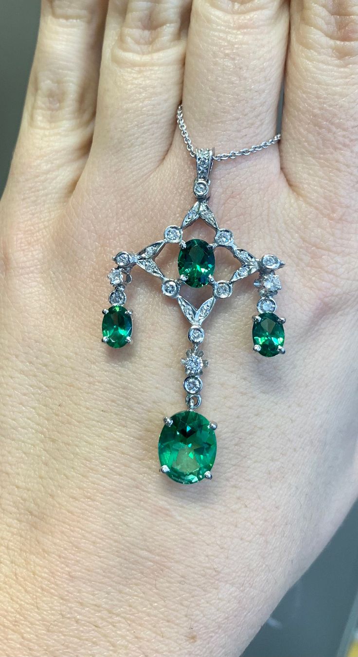 Metal: 14kt And 18kt White Gold Stone: Diamond And Green Topaz Stone Shapes: Round And Oval-shape Green Topaz Weight: 6.99 Carats Diamond Weight: .65 Carats Weight of entire piece with chain: 9.30 Grams Type of Chain: 14kt White Gold 2 mm Cable Chain Length Of Necklace: 18 Inches and can be cut shorter per your request. Type Of Closer: Lobster Clasp Length Of Pendant: 54mm Width Of Pendant: 30mm Elegant Gia Certified Gemstones, Classic Hallmarked Emerald Necklace With Diamonds, Classic Hallmarked Emerald And Diamond Necklace, Classic Emerald And Diamond Necklace, Classic Hallmarked Diamond Emerald Necklace, Elegant Tsavorite Gemstones For Anniversary, Briolette Emerald Necklace For Formal Occasions, Elegant Brilliant Cut Emerald Gemstones, Gia Certified Elegant Emerald Gemstones