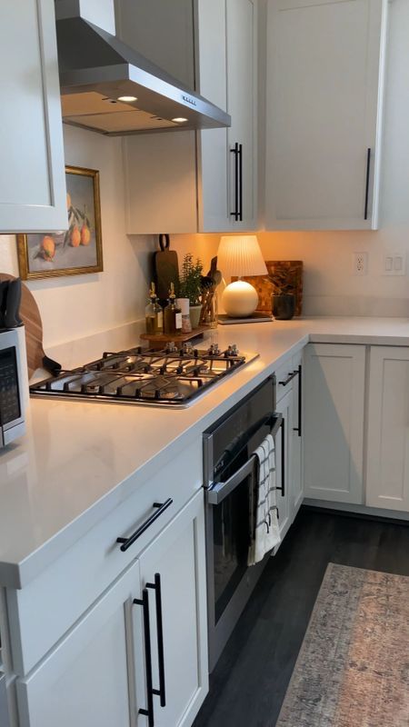 a kitchen with white cabinets and an oven