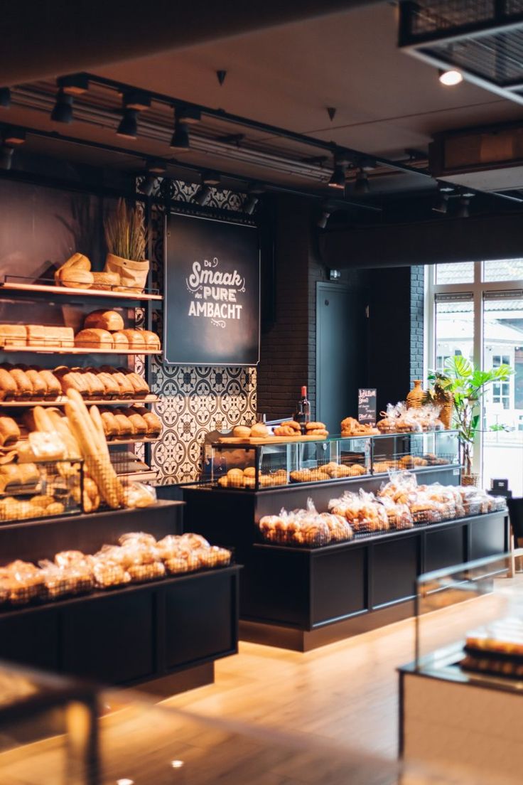 a bakery filled with lots of different types of breads and pastries on display