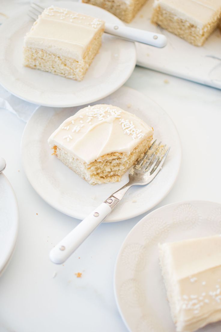 slices of cake sitting on white plates with forks