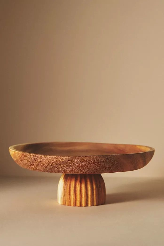 a wooden plate sitting on top of a table