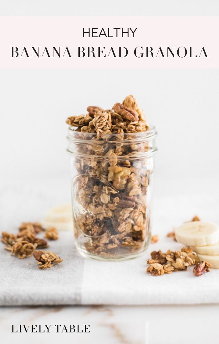 a glass jar filled with granola sitting on top of a table