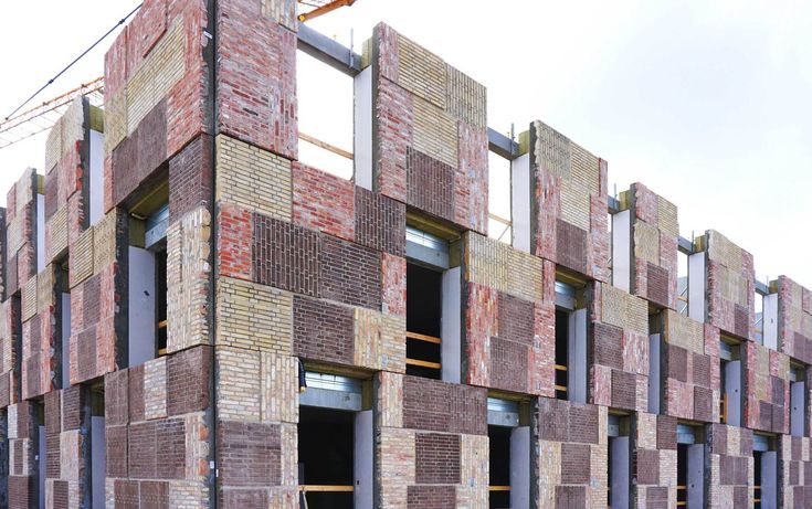 the building is made out of bricks and has scaffolding on it's sides