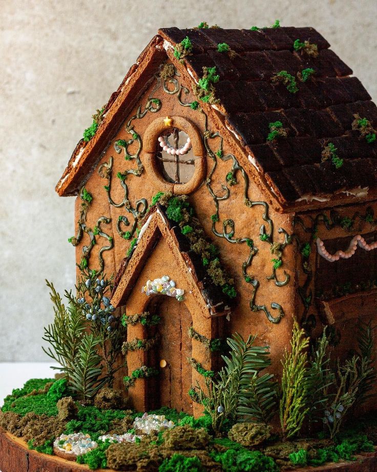 a gingerbread house with ivy growing on the roof