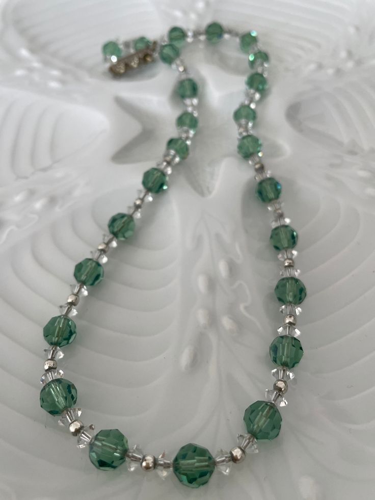 Vintage French Crystal Necklace, Sparkling Green Lovely and original very vintage French crystal necklace. Soft green faceted crystal with small clear spaces and tiny silver beads, all strung on fine silver chin. Gorgeous color and lots of sparkle. 18.5 inches long. Ornate bar clasp is missing on stone.  Found outside Antibes. Shipping will resume on Oct. 28 when I return from France. Silver Crystal Necklace With Spacer Beads As Gift, Green Crystal Beaded Necklaces As Gift, Crystal Beaded Necklaces With Silver Beads As A Gift, Green Crystal Beaded Necklace For Gift, Silver Crystal Beaded Necklace With Spacer Beads, Crystal Necklaces With Silver Beads For Jewelry Making, Crystal Necklaces With Silver Beads For Gift, Crystal Necklaces With Silver Beads As Gift, Silver Faceted Crystal Necklaces With Round Beads