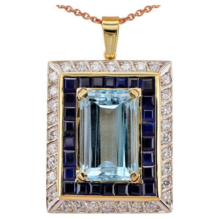 A Must Have This remarkable vintage pendant is 1960 ca Classy ever green style of high end jewellery Entirely hand crafted as unique of solid 18 KT gold and some platinum portions beautiful net design taking inspiration by the shape of the main Aquamarine rectangular Emerald cut set in a fantastic colour composition to make it grand and quite unique Craftsmanship is clean and accurate in all aspects The principle Aquamarine is a known weight of 17.50 Ct. (21.4 mm. x 12.9 mm.) – 100% natural – beautiful Sky Blue colour with a lovely aqua phenomena to it typical of this appealing gemstone Aquamarine is skillfully framed by an intense row of Royal Blue Natural Sapphires – square faceted French cut for 6.0 CT TCW beautiful framed in a gold border just slightly raised from the background of Pla Colour Composition, Sapphire Diamond Pendant, Net Design, Blue Tone, Gold Border, Green Style, Vintage Pendant, Natural Blue Sapphire, Natural Aquamarine