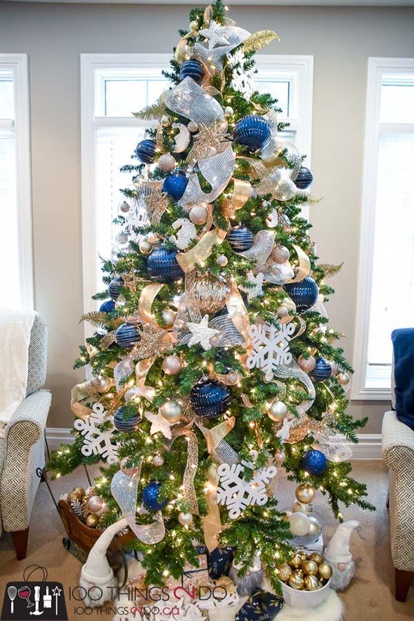 a christmas tree decorated with blue and gold ornaments