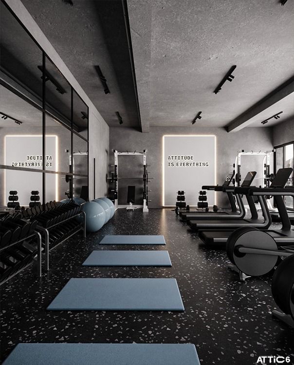 an empty gym with rows of treadmills and exercise mats lined up on the floor