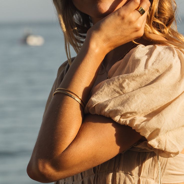 Be irresistibly stylish with this beautiful set of three gold bangle bracelets. Perfect for all occasions, these timeless pieces are sure to make any outfit look chic and modern. Dare to dazzle and embrace your unique style! How will you wear yours? Available in 14k gold plated brass Lucy, Maren and Demi Bangle Bracelets Width: 2mm each Interior diameter measures 2 1/2" Made in the USA SKU: STB1014 Chic Everyday Bangle Bracelets, Chic Adjustable Yellow Gold Bracelet, Elegant Double Band Gold Cuff Bracelet, Elegant Double Band Gold Bangle, Elegant Gold Double Band Cuff Bracelet, Elegant Gold Double Band Bangle, Modern Stackable Cuff Bracelet, Chic Yellow Gold Jubilee Bracelet, Chic Jubilee Bangle Bracelet