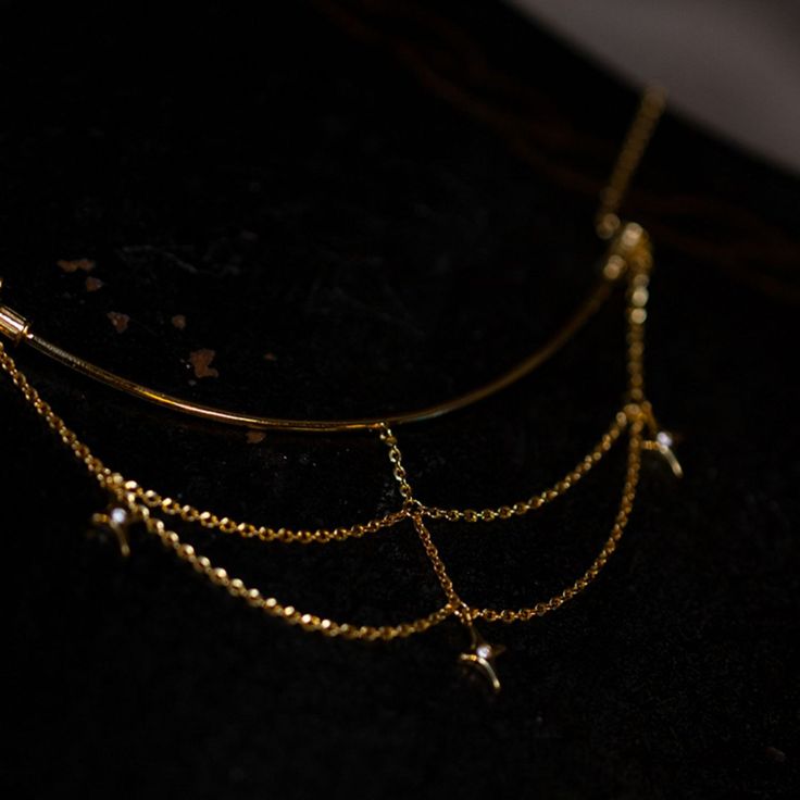 A necklace that looks like a constellation connecting stars. A design with a golden chain hanging down. Glossy stars emit a dazzling light. It has an elegant atmosphere as it sways every time you walk. A retro item with an exotic scent. 
 
 
 Item 
 
 Necklace 
 
 
 Size 
 
 Necklace decoration part 
 
 Height: 5.3cm 
 Width: 9.4cm 
 
 
 
 Material 
 
 Alloy 
 
 
 Others 
 
 If you have a metal allergy or the plating does not suit your skin, please refrain from ordering. Celestial Clavicle Chain Necklace For Party, Elegant Gold-tone Jewelry With Star Charm, Gold Dainty Necklaces For Evening, Elegant Gold Necklace With Star Charm, Gold Plated Clavicle Chain Necklace For Party, Dainty Gold Necklace For Evening, Celestial Party Jewelry With Adjustable Chain, Elegant Brass Necklace With Satellite Chain, Elegant Gold Chain Necklace With Star Charm