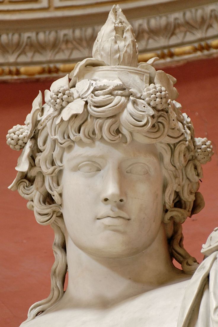 a close up of a statue of a person wearing a crown