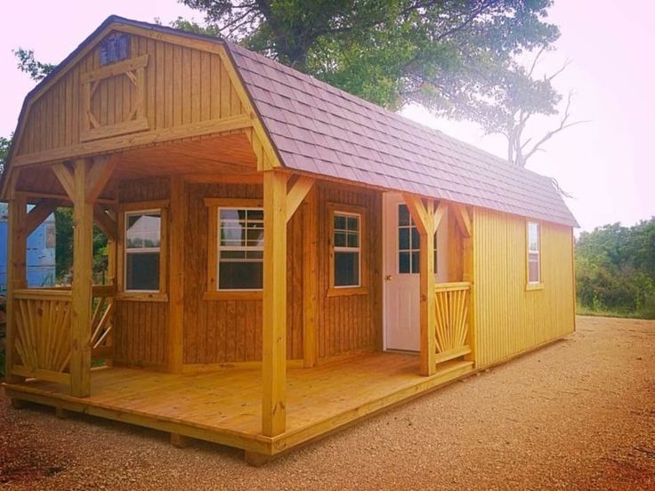 a small wooden cabin with a porch and covered patio