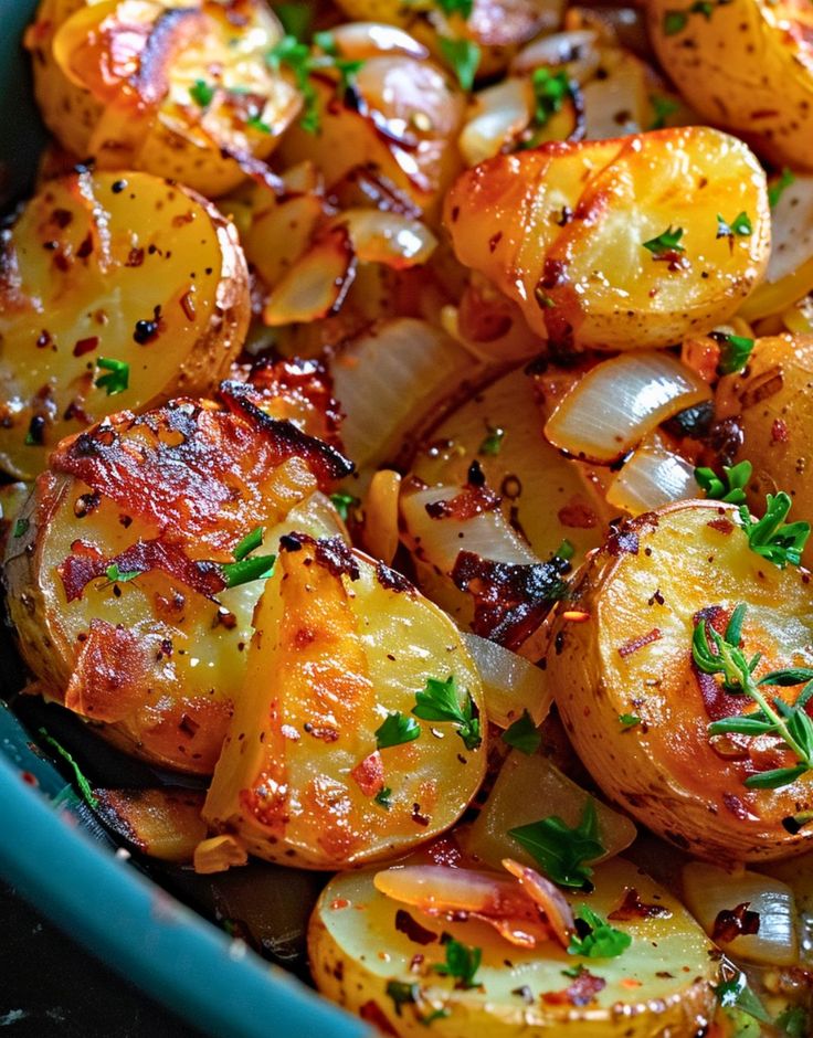 a blue bowl filled with potatoes and onions