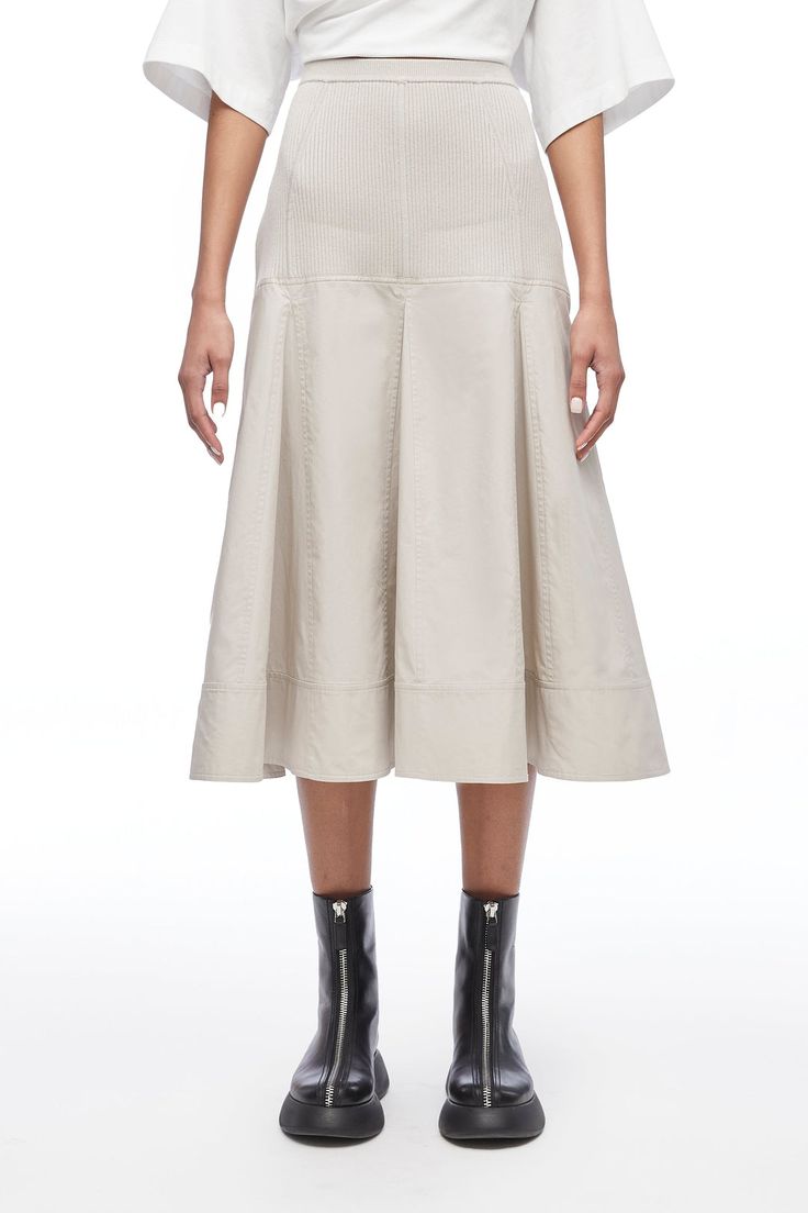 Focused, feminine and versatile is how creative director, Phillip Lim described our knitwear this season. And nowhere is that more apparent than in the viscose knit poplin midi skirt. This elegant A-line has a wide, subtle pleat and mid-calf hemline that imbues a soft femininity and makes it perfect for transitional seasons. Wear it with bare legs and a strappy sandal in late spring and summer, and with the Naomi soft bootie and tights as the weather cools. It is the perfect expression of our ro Chic Cotton A-line Pleated Skirt, Chic Midi Dress With Flared Skirt For Work, Chic Flared Midi Dress For Work, Cotton Midi-length Pleated Skirt For Work, Cotton Pleated Midi Skirt For Work, Spring Midi Dress With Box Pleat And Full Skirt, Pleated Full Skirt Midi Dress For Work, Spring A-line Midi Dress With Pleated Skirt, Relaxed Spring Skirt With Wide Hem