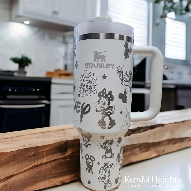 a mickey mouse travel mug sitting on top of a counter