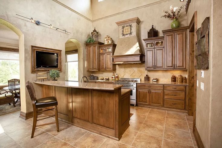 a large kitchen with wooden cabinets and marble counter tops