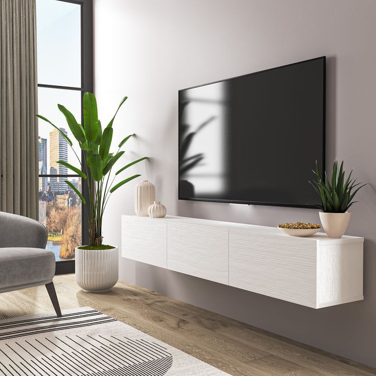 a large flat screen tv mounted to the side of a wall in a living room