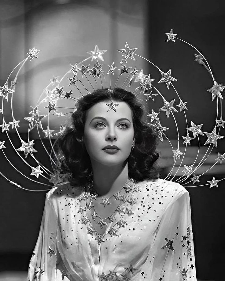 a woman with stars on her head in black and white