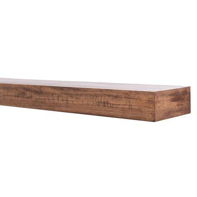 a wooden shelf sitting on top of a white wall