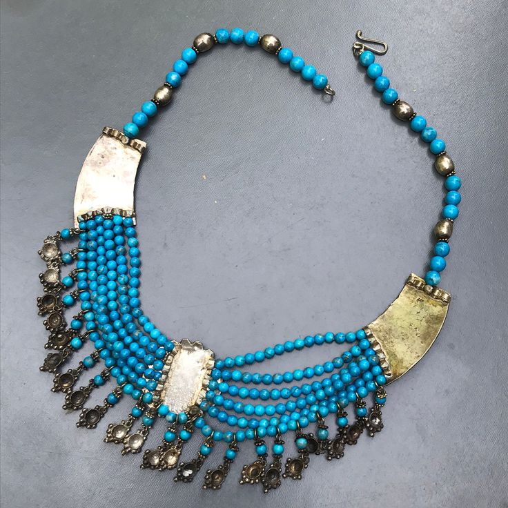 "Absolutely stunning ~ Vintage ~ Art Deco , Egyptian revival Style ~ Hand crafted ~ sterling silver Bib Necklace from India ~ Front of necklace features three silver panels with applied wire and bead work which are connected to each other by layers of dyed stones beads made to look like turquoise ~ Necklace ends with a chain and simple \"J\" hook and \"O\" ring at the end . Dates probably 1960's -1980's ~ Marked 925 on backside of panels . Materials : Sterling silver dyed stones beads Measuremen Hallmarked Pendant Necklace, Ceremonial Silver Beads Pendant Jewelry, Vintage Polished Beads Necklaces, Ceremonial Silver Beaded Pendant Jewelry, Artisan Brass Necklace With Polished Beads, Vintage Polished Metal Bead Jewelry, Vintage Metal Jewelry With Polished Beads, Silver Pendant Jewelry With Polished Beads, Silver Brass Costume Jewelry Necklace