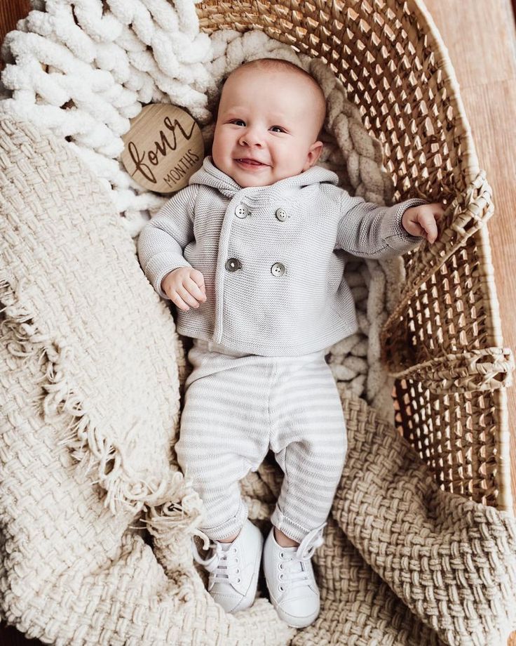 a baby is laying in a wicker basket with a tag that says love on it