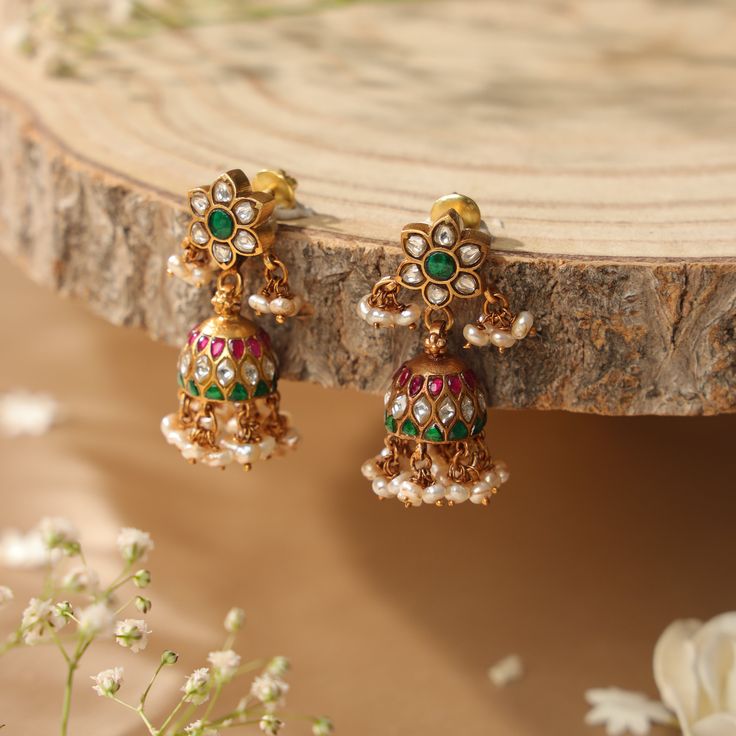 The collection showcases pieces inspired by South-Indian fashion and heritage style. Kundan Jadau jewelry, with its historic and enduring design, utilizes vibrant colors, traditional motifs, and close-setting gems, making it a cherished adornment for brides in India. Yamoona's interpretation of this jewelry results in timeless pieces that can be passed down for generations, offering a fresh and versatile perspective on this traditional art form.   All pieces in this collection are crafted from h Traditional Kundan Jhumkas With Motifs, Elegant Jhumkas For Diwali, Fusion Style Kundan Jhumkas For Wedding, Fusion Style Wedding Jhumkas With Latkans, Fusion Style Wedding Jhumkas For Festivals, Fusion Style Kundan Necklace With Latkans For Wedding, Elegant Wedding Earrings With Motifs, Fusion Meenakari Jhumkas For Wedding, Fusion Style Meenakari Jhumkas For Wedding