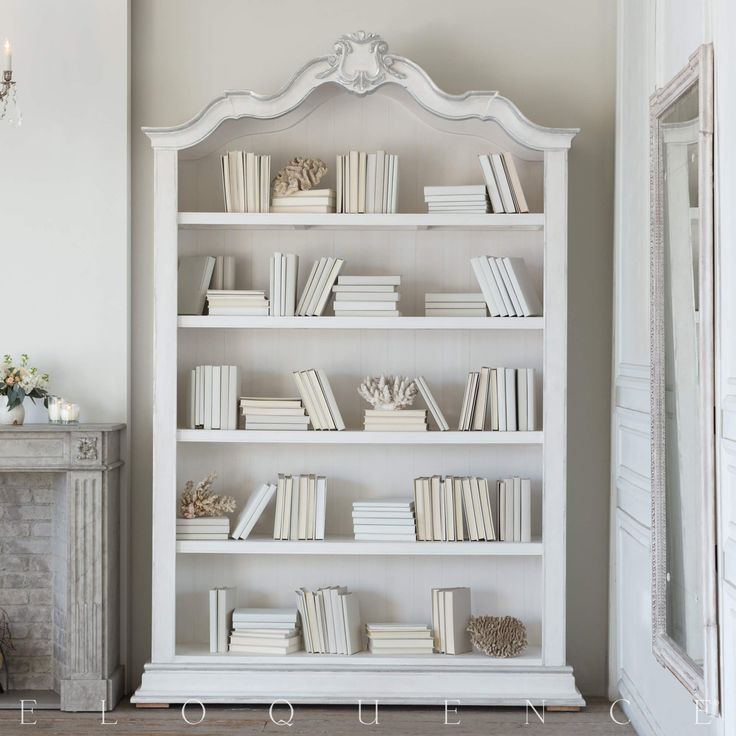 a white book shelf with books on it