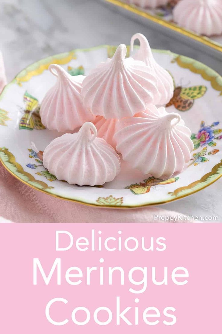 three pink meringue cookies sitting on top of a plate next to each other