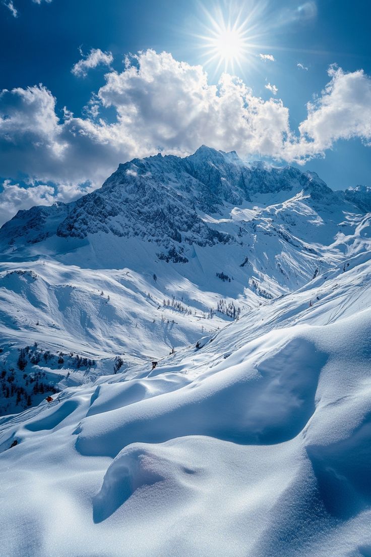 the sun shines brightly over snow covered mountains