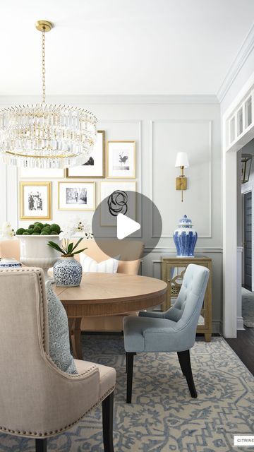 a living room filled with furniture and a chandelier hanging from the ceiling over a table