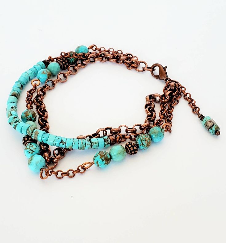 "This bracelet features beautiful genuine turquoise beads in 2 styles. Faceted round and disk aqua blue turquoise beads have flecks of copper that add texture and match the antique copper chain perfectly. There are 2 styles of copper rollo chain and copper beads setting off the turquoise beads. A wonderful, casual everyday sort of bracelet; happy all by itself, super accommodating when piled on with your other favorites! One strand is entirely copper chain. One features disk style beads accented with chain. The other strand is a mix of round faceted turquoise beads set off with copper heishi beads and accented with copper chain. The strands meet in a ring and the bracelet features a lobster clasp for security. A delicate chain dangle features turquoise beads at then end. This bracelet is m Handmade Turquoise Copper Bracelets, Handmade Turquoise Copper Bracelet, Turquoise Multi-strand Wrap Bracelet, Bohemian Turquoise Beaded Metal Bracelets, Bohemian Multi-strand Nickel-free Bracelets, Bohemian Copper Bracelets With Patina, Bohemian Multi-strand Nickel Free Bracelets, Bohemian Copper Bracelet With Patina, Turquoise Multi-strand Hand Wrapped Bracelets