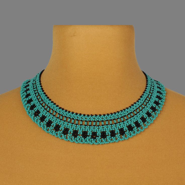 "A turquoise necklace is a stylish and original decoration. A seed bead necklace will make you more tender and sophisticated. A modern necklace will be a wonderful birthday gift for sister. Despite the size, the bead necklace is not heavy.  A boho necklace is suitable for any look and is easily combined with clothes of different styles. All beaded jewelry in our assortment is unique. Each product has its own style and original design. Nevertheless, many pieces of jewelry are easily combined with each other, creating an unforgettable image. ------------------ The turquoise jewelry is one of the best gift ideas. At SweetBeadsIP, you will find a gift for everyone - gift for a girlfriend, gift for mother, gift for sister, or gift for daughter. This  handmade necklace is crafted with Czech bead Elegant Handmade Turquoise Beaded Necklaces, Turquoise And Black Beads Necklace For Jewelry Making, Turquoise Tiny Beads Choker Necklace, Turquoise Beaded Bib Necklaces, Handmade Turquoise Bib Necklace With Round Beads, Handmade Elegant Turquoise Choker, Elegant Handmade Turquoise Choker, Elegant Turquoise Crystal Necklaces With Colorful Beads, Elegant Turquoise Crystal Necklace With Colorful Beads