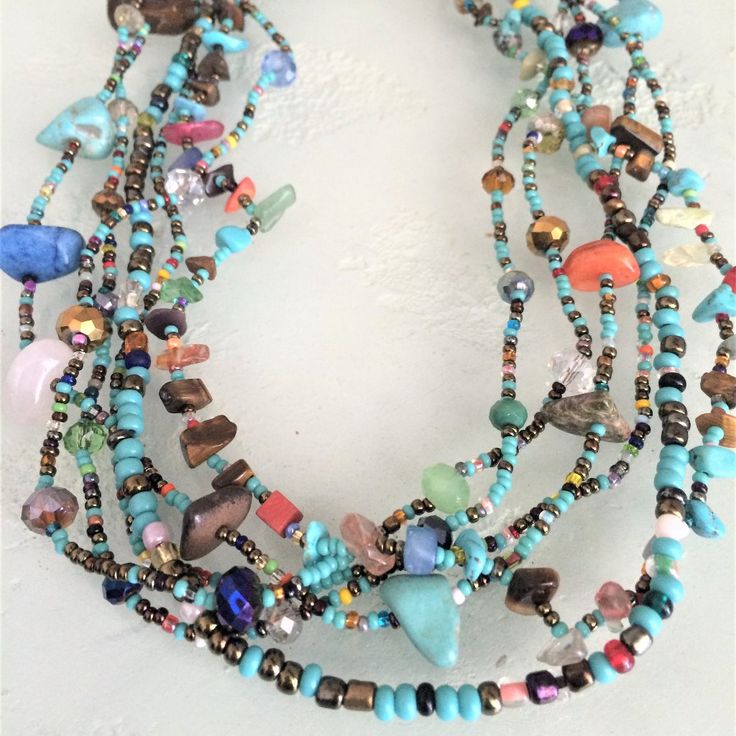 Artisan Czech Glass Bead 6 Strand 18" Long Fashion Statement Necklace Turquoise, Multi-Colors A Total Length Of 18" Long, With Glass Beads & Semi Precious Stone Chips. Easy To Open/Close Magnetic Clasp. One Of A Kind Necklace Handcrafted/No Two Are Exactly Alike Czech Glass Beads Are Know World Wide For Their Quality, Vibrant Colors Handmade In Guatemala Using Artisan Crafted Czech Glass Beads. Principles Of Fair Trade Are Upheld. Beaded Bohemian Czech Glass Crystal Necklace, Bohemian Beaded Czech Glass Crystal Necklaces, Bohemian Beaded Czech Glass Crystal Necklace, Turquoise Beaded Czech Glass Necklace, Spiritual Turquoise Beaded Necklace With Spacer Beads, Spiritual Turquoise Crystal Necklace With Polished Beads, Multicolor Large Beads Turquoise Necklace For Festivals, Multicolor Beaded Turquoise Necklace For Festivals, Turquoise Multi-strand Beaded Necklace For Festivals