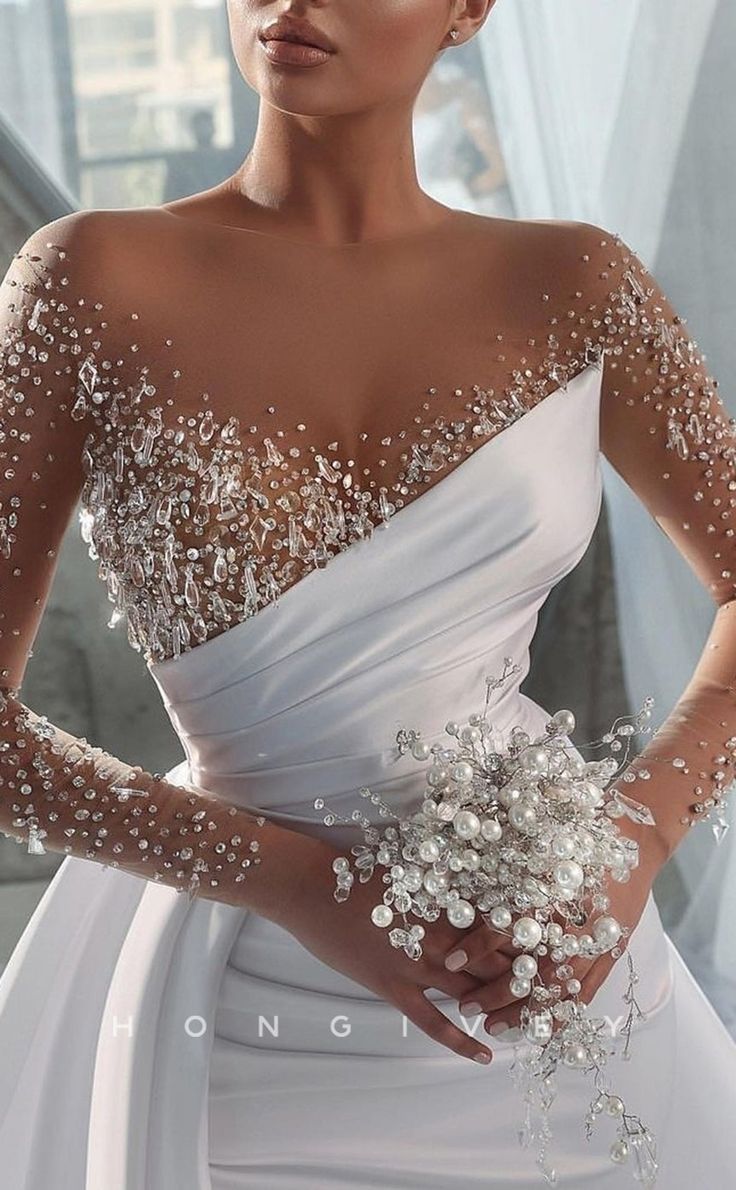 a woman in a white wedding dress holding flowers